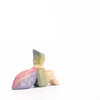 Eric & Albert wooden toy fairy in green sitting on the ground with pinky purple wings | © Conscious Craft